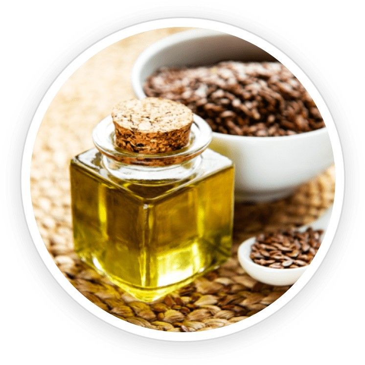 Golden flaxseed oil in a small container beside flax seeds, highlighting omega-3-rich nail support.